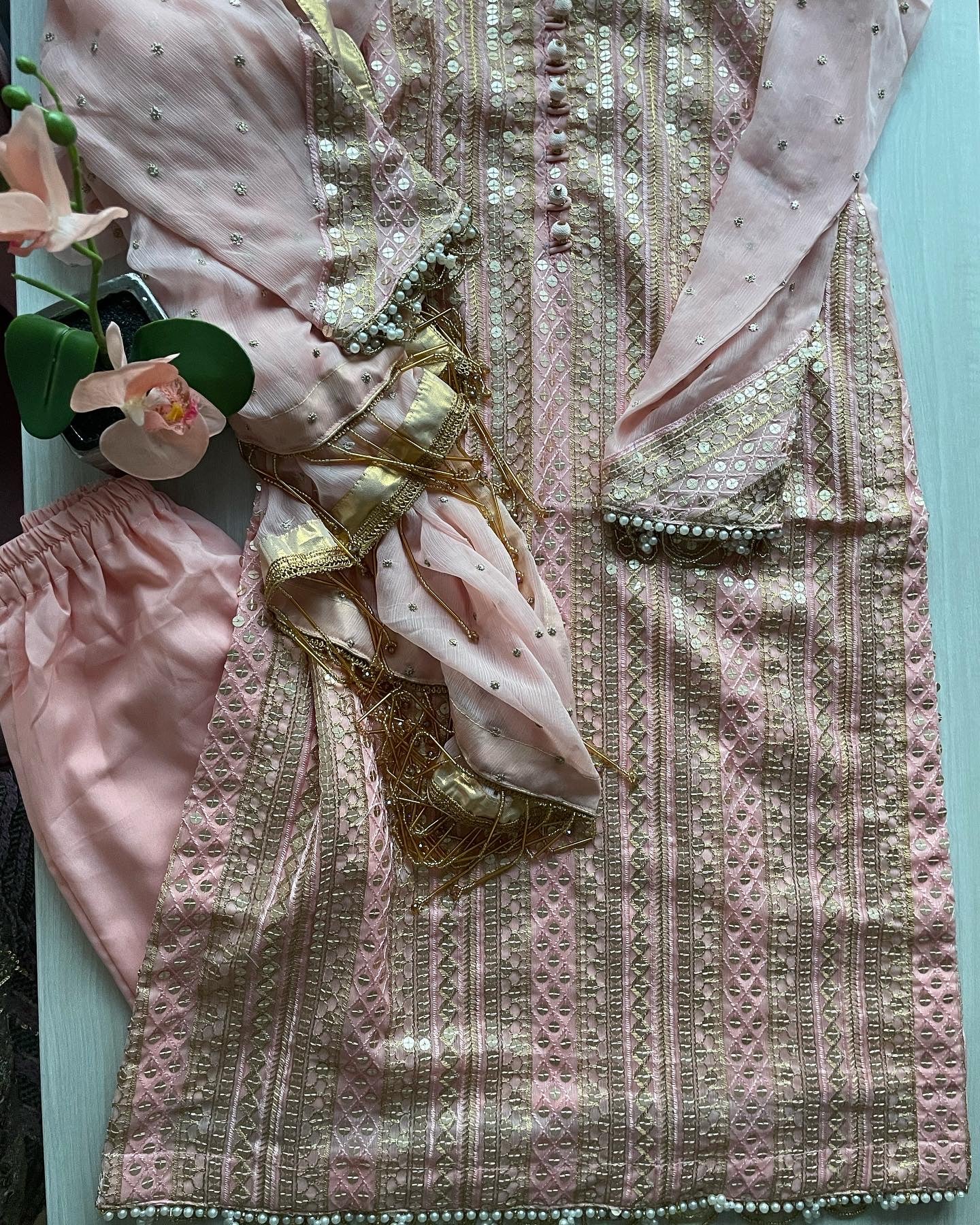 Pink chiffon suit with gold tassels