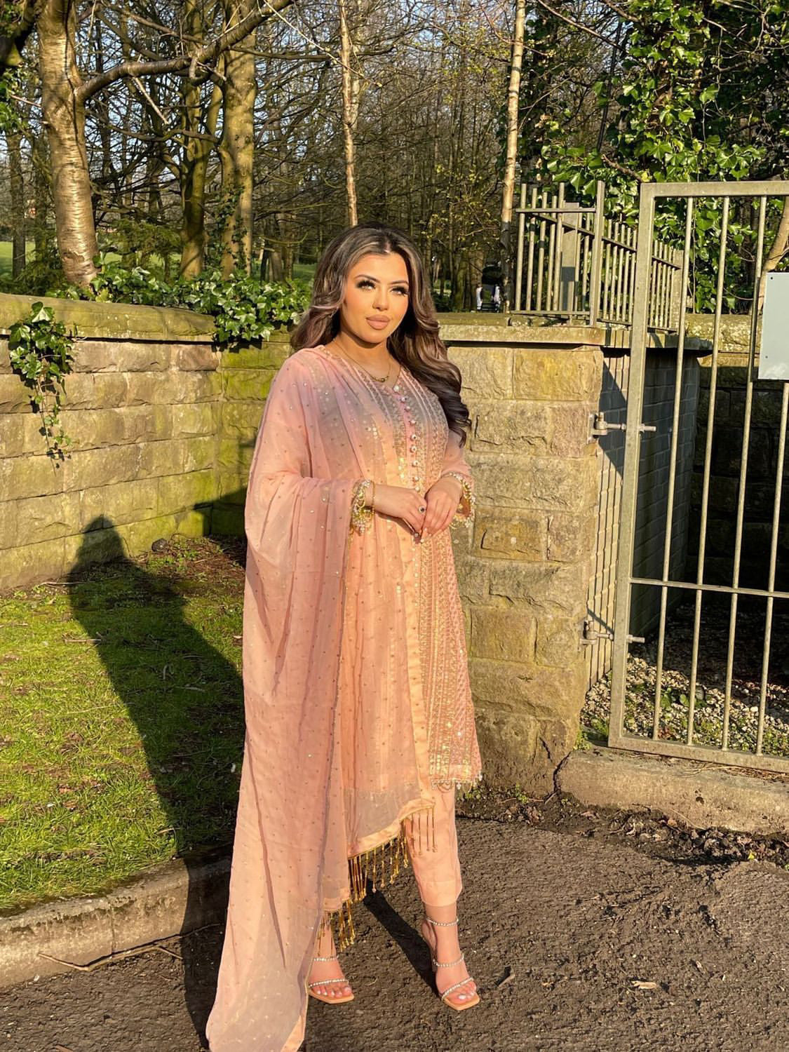 Pink chiffon suit with gold tassels