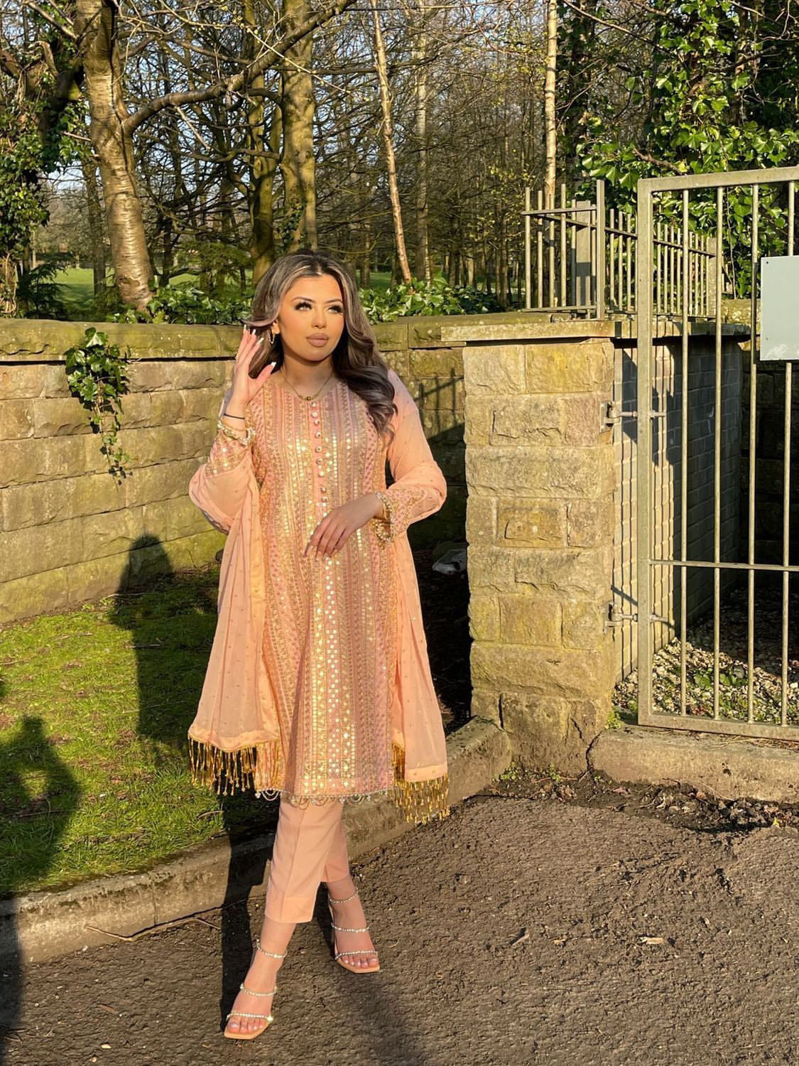 Pink chiffon suit with gold tassels