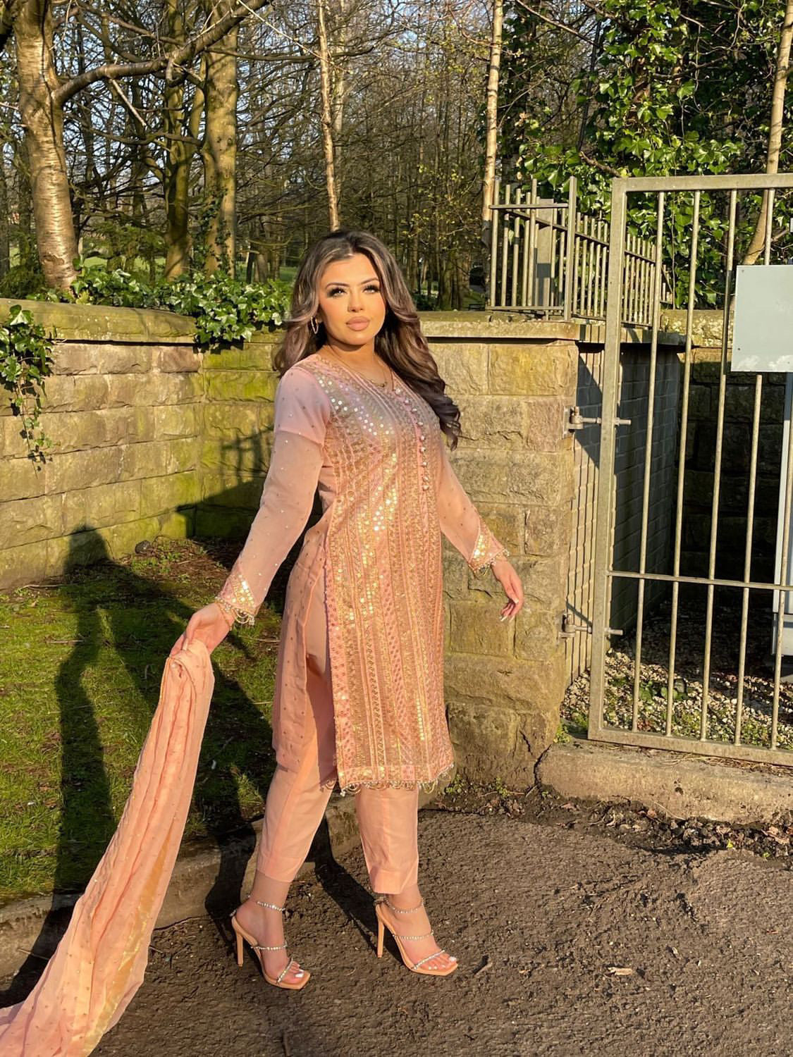 Pink chiffon suit with gold tassels
